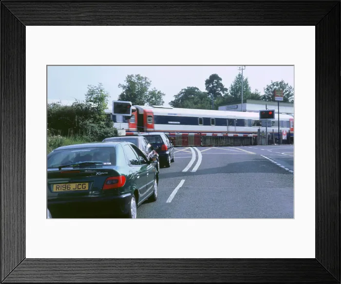 Framed Print : Traffic queue at level crossing in Brockenhurst, Hampshire Framed Print : Traffic queue at level crossing in Brockenhurst, Hampshire