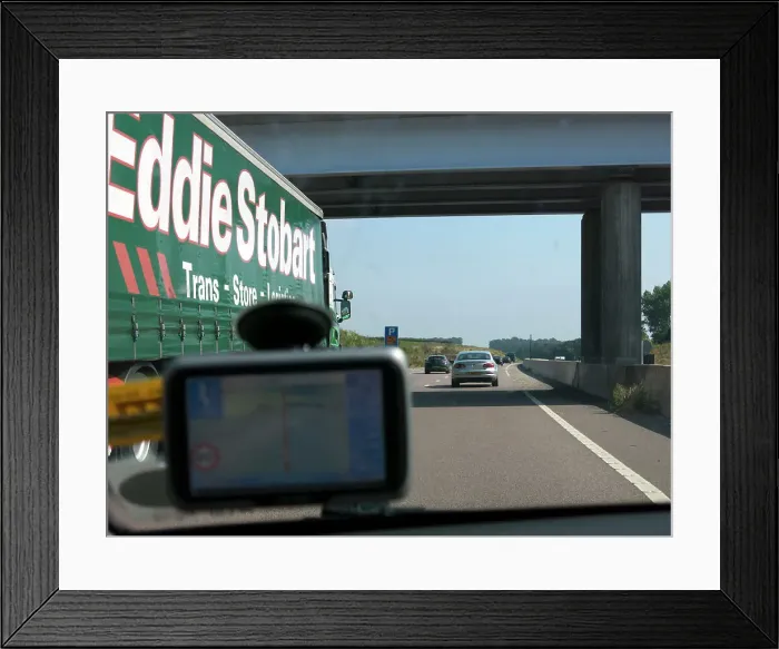 Framed Print : Passing Eddie Stobart truck on the A46 with satnav screen on windscreen Framed Print : Passing Eddie Stobart truck on the A46 with satnav screen on windscreen