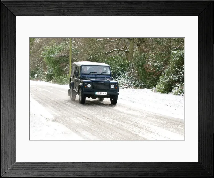 Framed Print : 2002 Land Rover Defender driving on snowy road, 2009 Framed Print : 2002 Land Rover Defender driving on snowy road, 2009