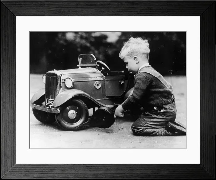 Framed Print : Michael Ware repairing a pedal car Framed Print : Michael Ware repairing a pedal car