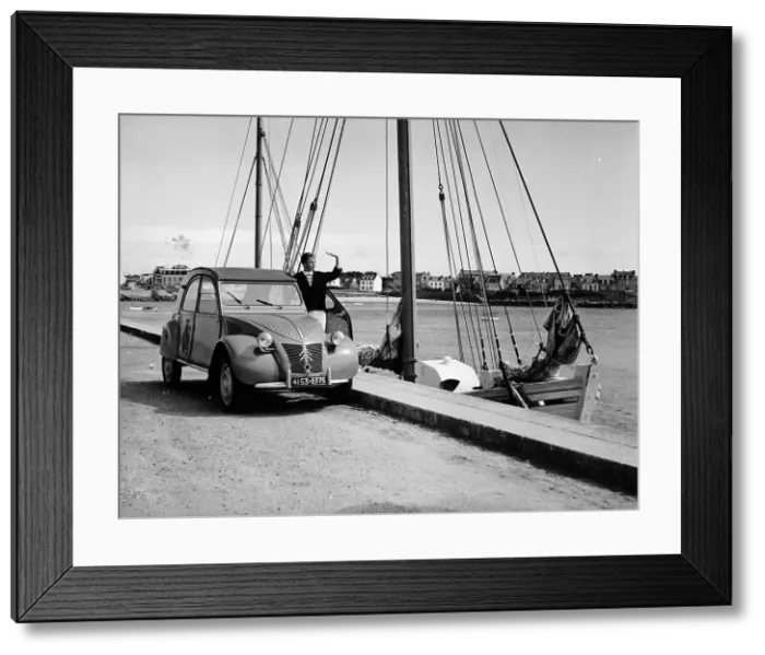 Framed Print : A Citroen 2CV on the quay at a harbour, c1957