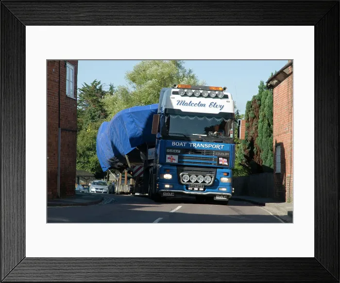 Framed Print : DAF 95 XF wide load truck carrying a life boat through a small village Framed Print : DAF 95 XF wide load truck carrying a life boat through a small village