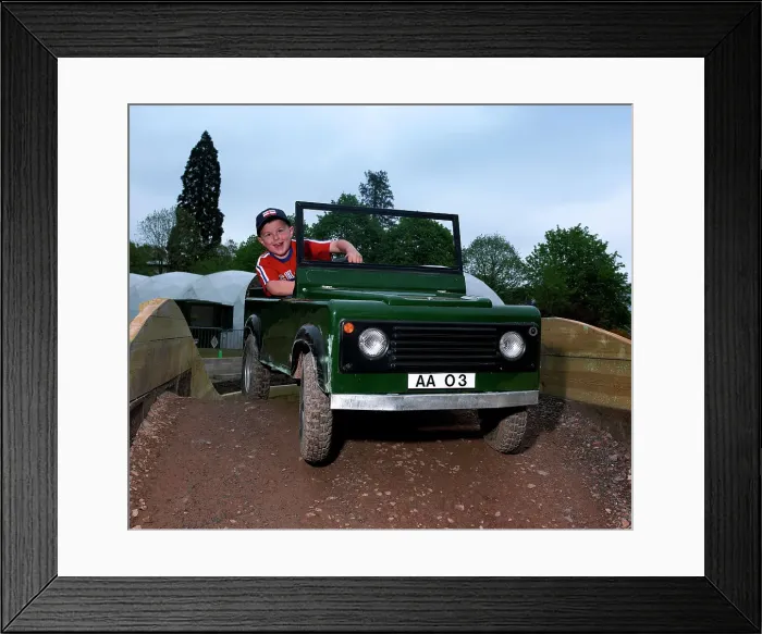 Framed Print : Child driving a toy Land Rover Framed Print : Child driving a toy Land Rover