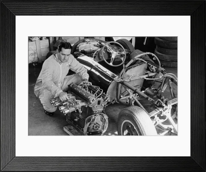 Framed Print : Jack Brabham inspecting the engine of a car Framed Print : Jack Brabham inspecting the engine of a car