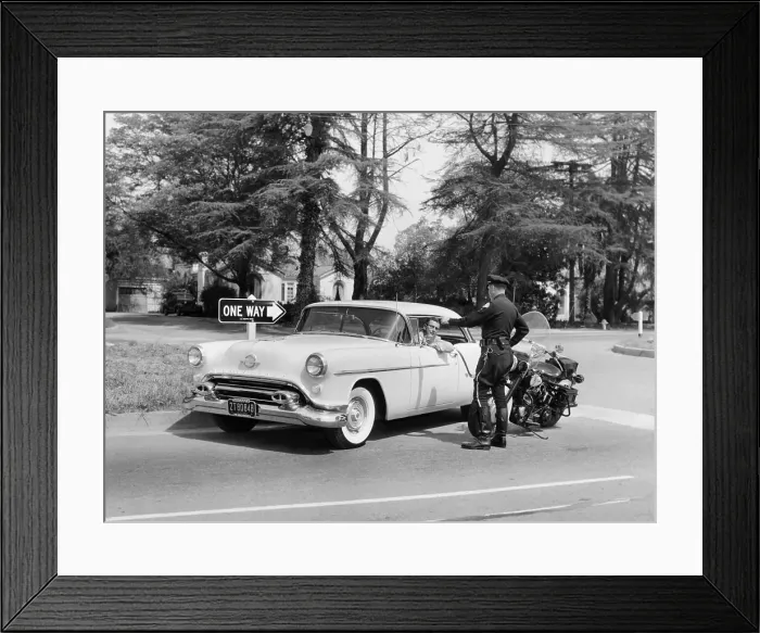 Framed Print : An Oldsmobile at the corner of an American street, 1954