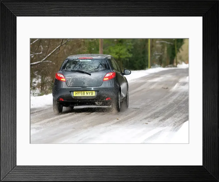 Framed Print : 2009 Mazda 2 driving on snowy road Framed Print : 2009 Mazda 2 driving on snowy road