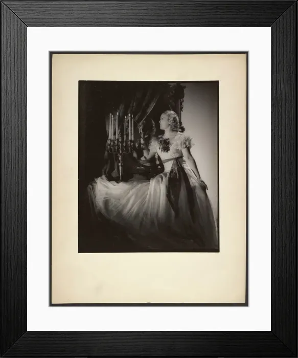 Framed Print : Woman lighting candelabra, 1930s. Creator: Gunther Krampf Framed Print : Woman lighting candelabra, 1930s. Creator: Gunther Krampf