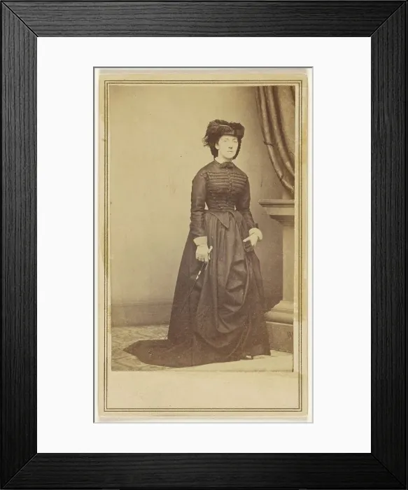 Framed Print : Unidentified woman wearing a hat and long dark dress, about 1868. Creator: Mathew Brady Framed Print : Unidentified woman wearing a hat and long dark dress, about 1868. Creator: Mathew Brady