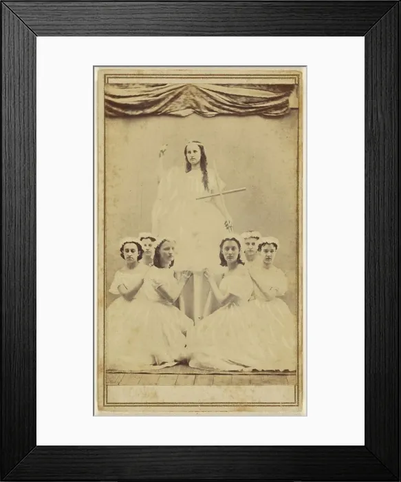 Framed Print : Female group portrait, six in white gowns kneeling, one standing holding a cross, about 1865. Creator: Unknown Framed Print : Female group portrait, six in white gowns kneeling, one standing holding a cross, about 1865. Creator: Unknown