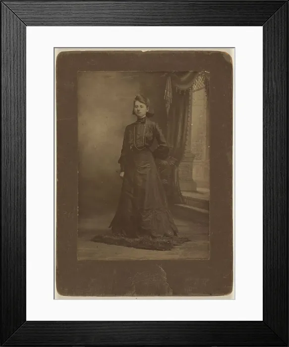 Framed Print : Portrait of a young woman in long black dress, standing, about 1900. Creator: George W Killian Framed Print : Portrait of a young woman in long black dress, standing, about 1900. Creator: George W Killian