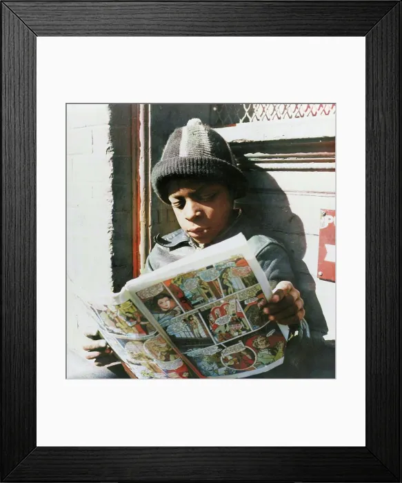 Framed Print : Negro youth reading a funny paper on a door step in the Southwest section, Washington, D.C. 1942. Creator: Gordon Parks Framed Print : Negro youth reading a funny paper on a door step in the Southwest section, Washington, D.C. 1942. Creator: Gordon Parks