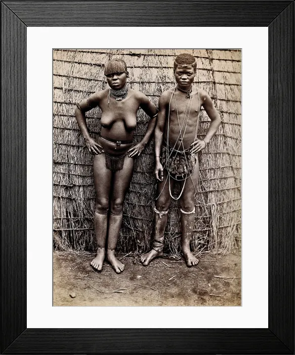 Framed Print : Africa: an African woman and man in front of a kraal hut, 19th century. Creator: Unknown Framed Print : Africa: an African woman and man in front of a kraal hut, 19th century. Creator: Unknown