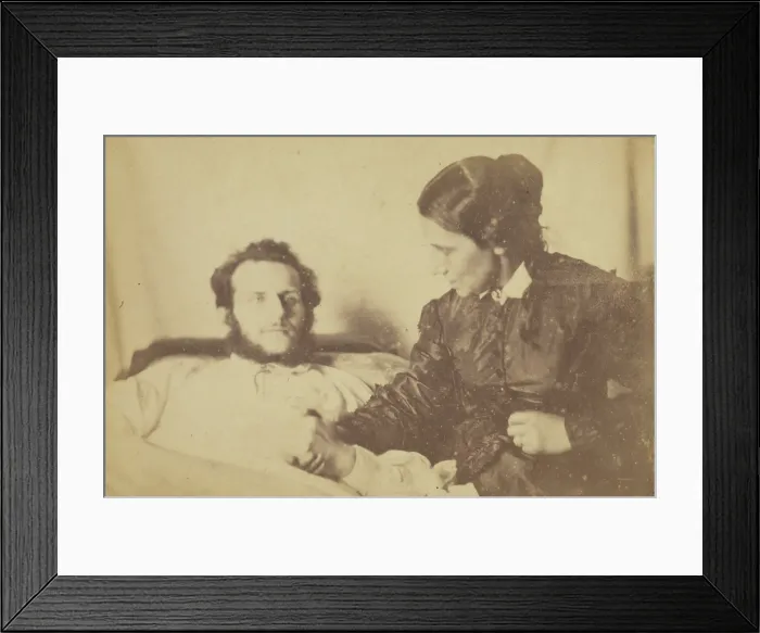 Framed Print : A bearded man lying in bed, his hand held by his wife who is seated next to the bed, 1870-79. Creator: Unknown Framed Print : A bearded man lying in bed, his hand held by his wife who is seated next to the bed, 1870-79. Creator: Unknown