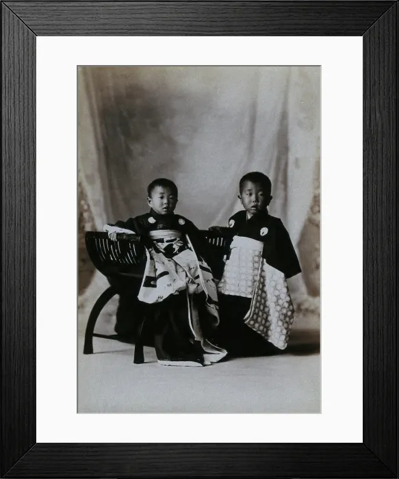 Framed Print : Two boys in a photographic studio, one seated on a chair, in front of a curtained backdrop, c1900. Creator: Unknown Framed Print : Two boys in a photographic studio, one seated on a chair, in front of a curtained backdrop, c1900. Creator: Unknown