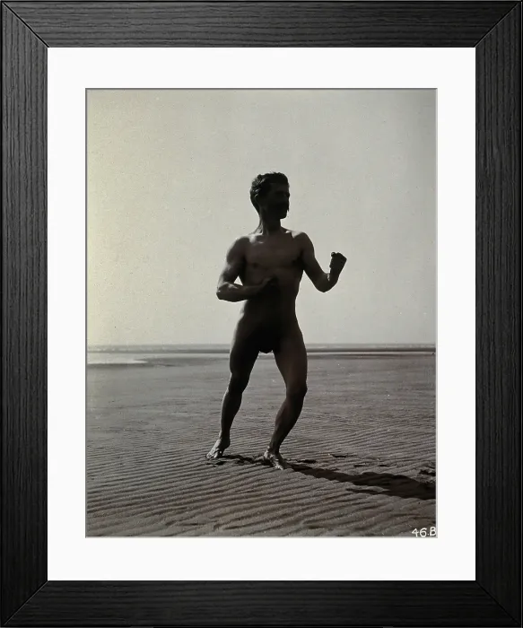 Framed Print : A man posing naked in a boxing stance with his fists raised, on a deserted beach, c1900. Creator: Unknown Framed Print : A man posing naked in a boxing stance with his fists raised, on a deserted beach, c1900. Creator: Unknown