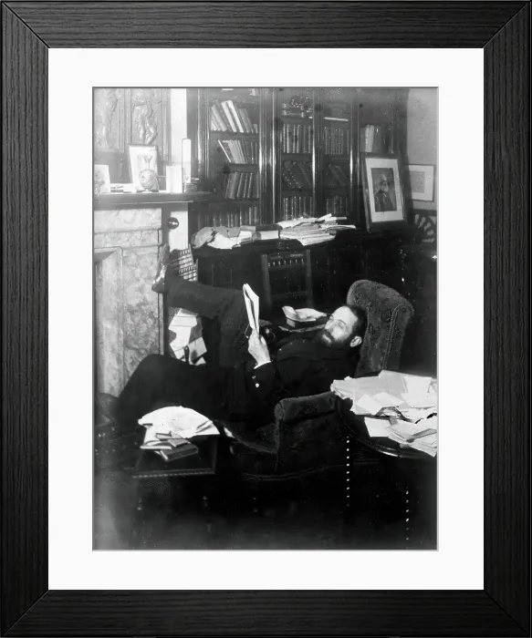 Framed Print : Arthur Schuster, lying on an armchair by a fireplace, with a photograph of Lord Kelvin... c1901. Creator: Unknown Framed Print : Arthur Schuster, lying on an armchair by a fireplace, with a photograph of Lord Kelvin... c1901. Creator: Unknown
