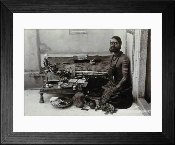 Framed Print : An Indian man wearing elaborate jewellery and make-up, squatting in front of a small table... c1900 Creator: Unknown Framed Print : An Indian man wearing elaborate jewellery and make-up, squatting in front of a small table... c1900 Creator: Unknown