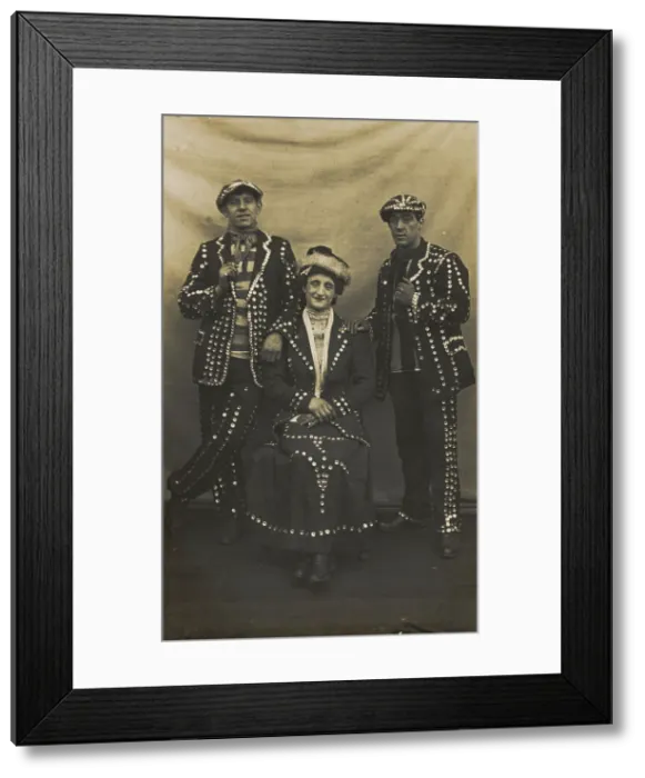 Framed Print : A drag pearly queen and her two kings pose for a group portrait, (between 1910 and 1919?). Creator: Unknown Framed Print : A drag pearly queen and her two kings pose for a group portrait, (between 1910 and 1919?). Creator: Unknown