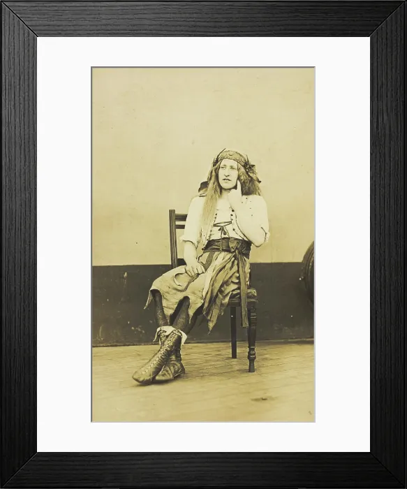 Framed Print : A man in drag sits pensively on a chair, on the deck of a ship, (between 1910 and 1919?). Creator: Unknown Framed Print : A man in drag sits pensively on a chair, on the deck of a ship, (between 1910 and 1919?). Creator: Unknown