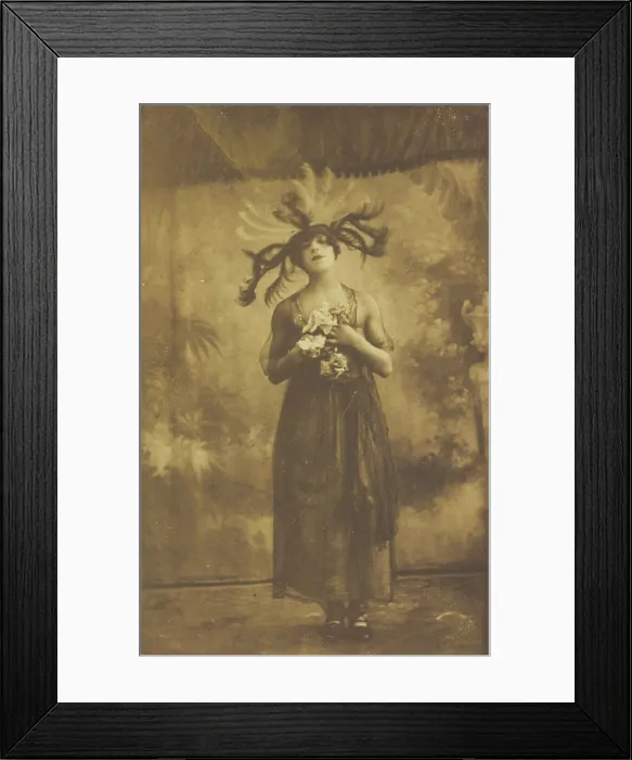 Framed Print : A performer in drag poses on stage wearing a head garment with sprawling feathers, [1910-1919?]. Creator: Unknown