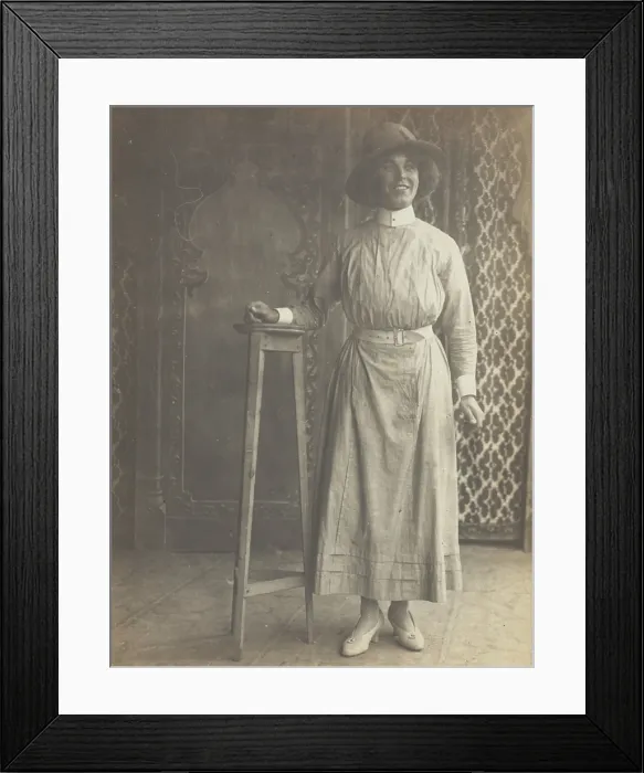 Framed Print : A sailor in drag leans on a high stool, in front of patterned scenery, (between 1910 and 1919?). Creator: Unknown Framed Print : A sailor in drag leans on a high stool, in front of patterned scenery, (between 1910 and 1919?). Creator: Unknown