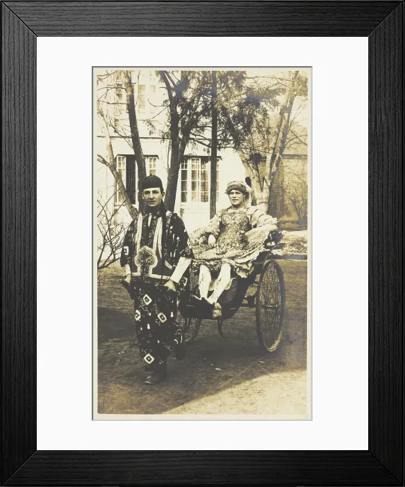 Framed Print : A man in ornate drag sits in a dog-cart and is pulled along the road by...(between 1910 and 1919?). Creator: Unknown Framed Print : A man in ornate drag sits in a dog-cart and is pulled along the road by...(between 1910 and 1919?). Creator: Unknown