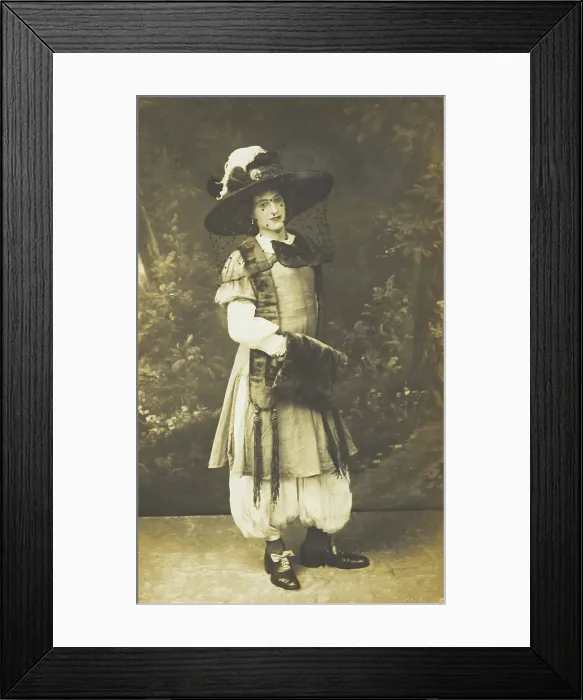 Framed Print : A man in drag wearing a very large hat with a veil, stands in front of a painted... 1911. Creator: Unknown Framed Print : A man in drag wearing a very large hat with a veil, stands in front of a painted... 1911. Creator: Unknown