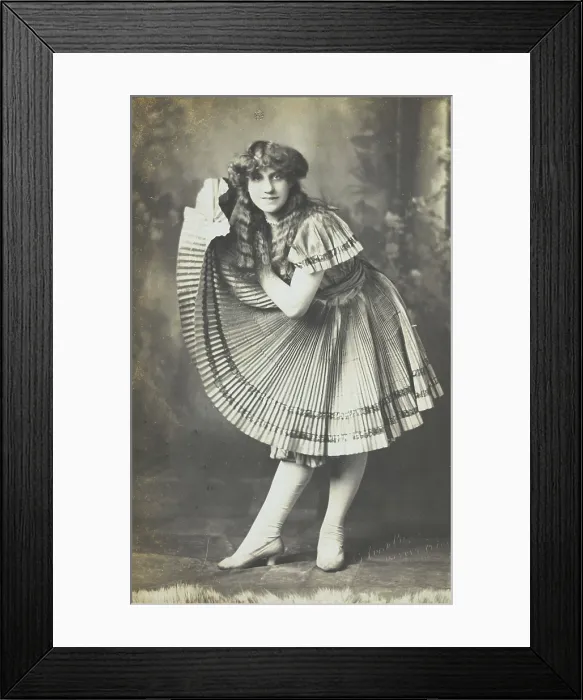 Framed Print : An amateur actor in drag holds up his impressive folded dress to one side, (between 1910 and 1919?). Creator: Unknown Framed Print : An amateur actor in drag holds up his impressive folded dress to one side, (between 1910 and 1919?). Creator: Unknown