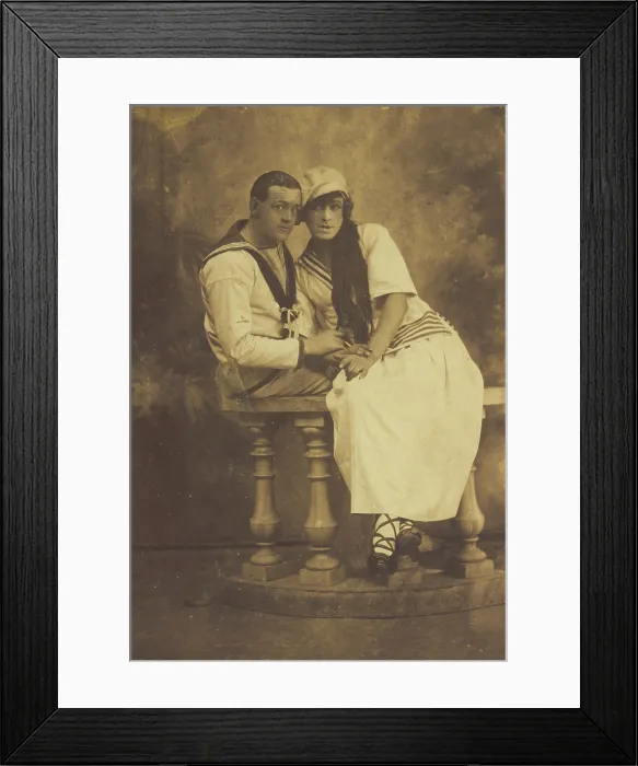 Framed Print : Two sailors, one in drag, embracing while sitting on a stage balcony, (between 1910 and 1919?). Creator: Unknown Framed Print : Two sailors, one in drag, embracing while sitting on a stage balcony, (between 1910 and 1919?). Creator: Unknown