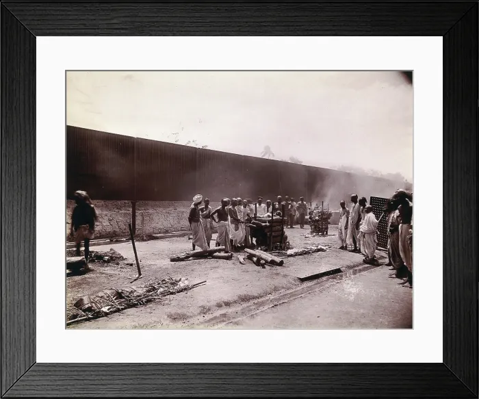 Framed Print : A group of men stand around the body of a man laid out on a pyre of logs during a Hindu... 1896 / 97 Creator: Unknown