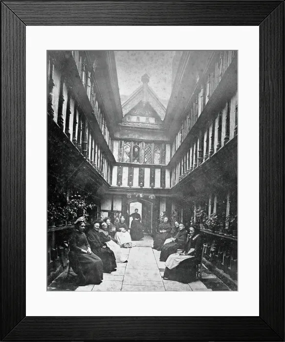 Framed Print : Ford's Hospital, Coventry: residents seated in the courtyard looking toward the street, c1880s Framed Print : Ford's Hospital, Coventry: residents seated in the courtyard looking toward the street, c1880s