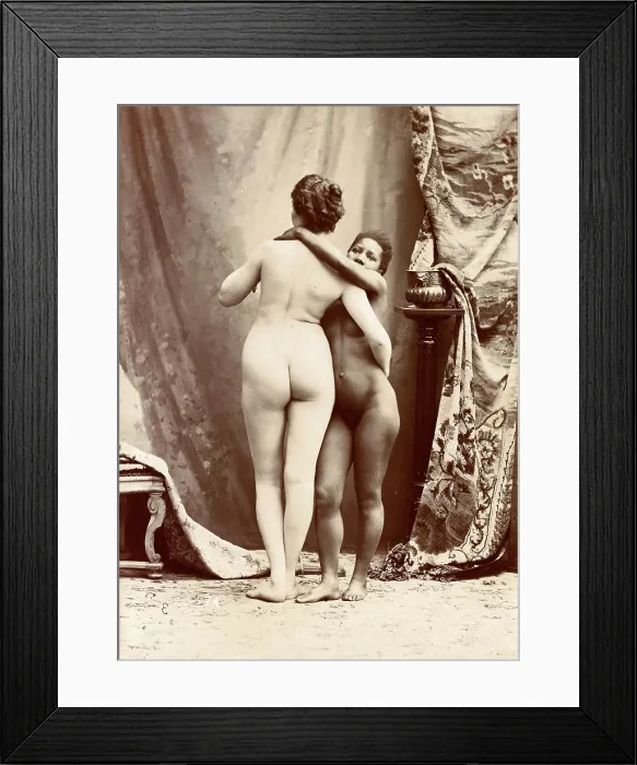 Framed Print : Two women posing naked in a photographic studio, standing embracing each other in front... c1900. Creator: Unknown Framed Print : Two women posing naked in a photographic studio, standing embracing each other in front... c1900. Creator: Unknown