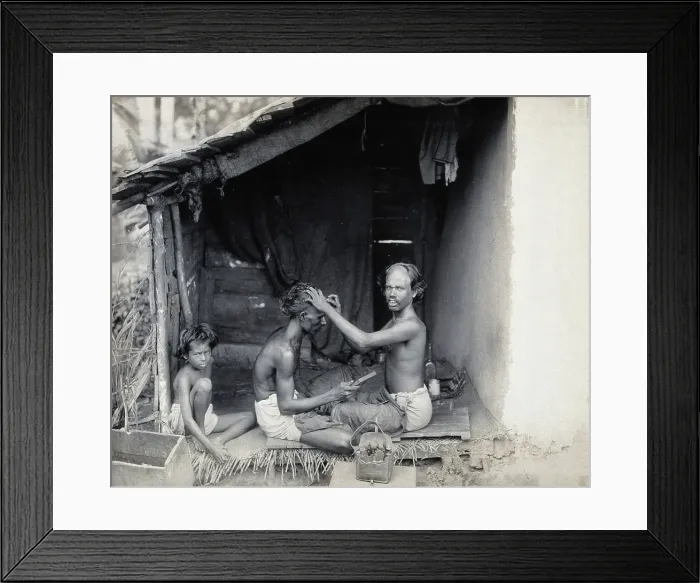 Framed Print : Two men sitting cross-legged; one is a barber shaving the front of the other's head, c1900 Framed Print : Two men sitting cross-legged; one is a barber shaving the front of the other's head, c1900