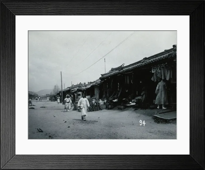 Framed Print : A line of shops beside a dusty street, with telegraph poles overhead, in Korea, c1900. Creator: Unknown Framed Print : A line of shops beside a dusty street, with telegraph poles overhead, in Korea, c1900. Creator: Unknown