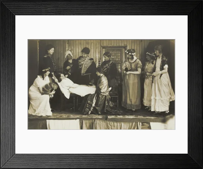 Framed Print : Amateur actors, some in drag, on stage attending to the death of a female character, [1910-1919?]. Creator: Unknown