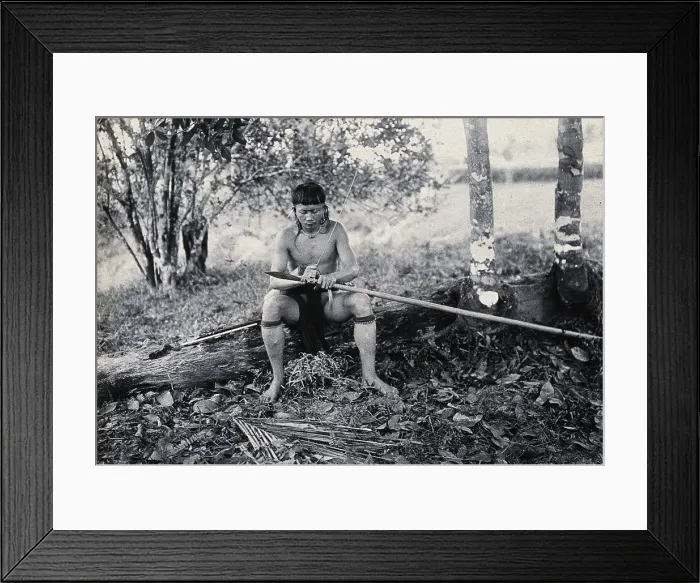 Framed Print : Sarawak: a Kenyah worker tying a spearhead to a blowpipe, c1900. Creator: Unknown