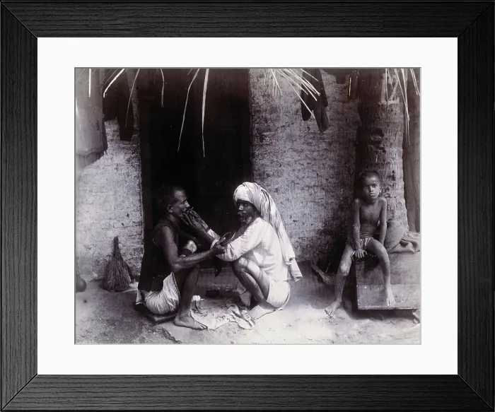 Framed Print : Two Indian men crouching; one is cutting the other's hair, while a girl sits.. c1890s Framed Print : Two Indian men crouching; one is cutting the other's hair, while a girl sits.. c1890s