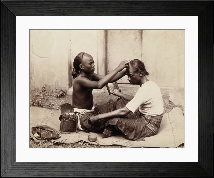 Framed Print : Two Indian men sitting cross-legged; one appears to be a barber... c1890s. Creator: Unknown Framed Print : Two Indian men sitting cross-legged; one appears to be a barber... c1890s. Creator: Unknown