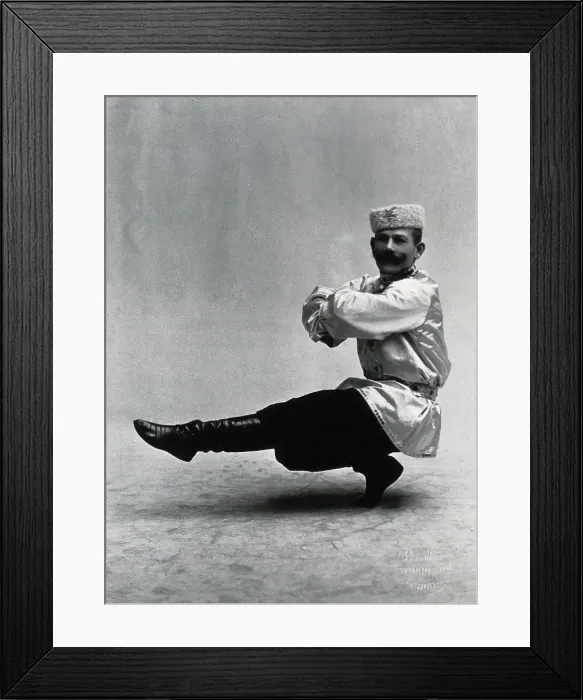 Framed Print : A man, in a satin tunic and fur hat, dancing a 'Cossack' measure in a studio setting, 1899-1908. Creator: Unknown Framed Print : A man, in a satin tunic and fur hat, dancing a 'Cossack' measure in a studio setting, 1899-1908. Creator: Unknown