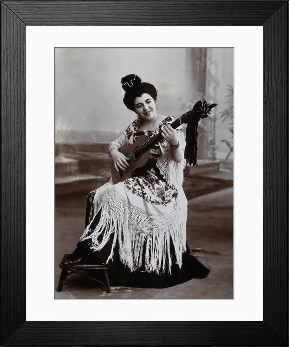 Framed Print : A seated woman, playing a guitar, wearing a fringed shawl, c1900. Creator: Unknown Framed Print : A seated woman, playing a guitar, wearing a fringed shawl, c1900. Creator: Unknown