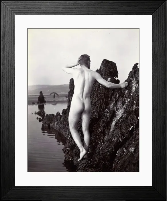 Framed Print : A man posing naked, with his back to the camera, standing on a rocky outcrop, c1900. Creator: Unknown Framed Print : A man posing naked, with his back to the camera, standing on a rocky outcrop, c1900. Creator: Unknown