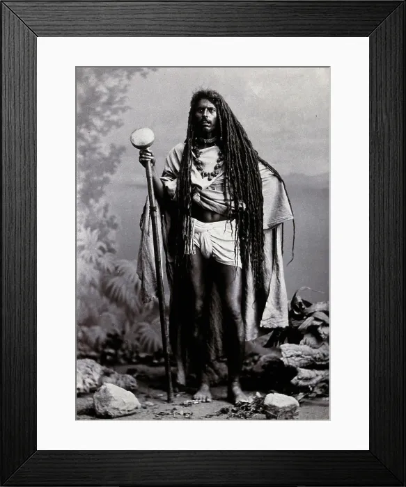 Framed Print : An Indian man with long hair, carrying a staff, in a studio setting, 1900. Creator: Unknown