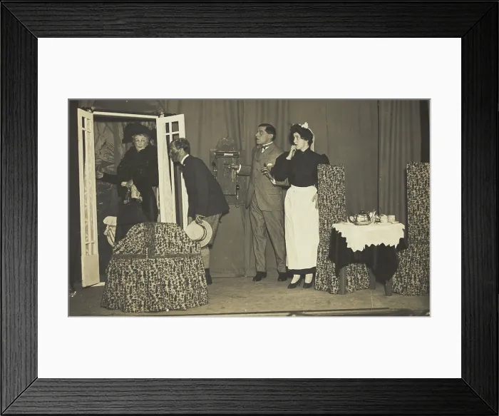 Framed Print : Amateur actors, one in drag, perform a scene on stage, [between 1910 and 1919?]. Creator: Unknown
