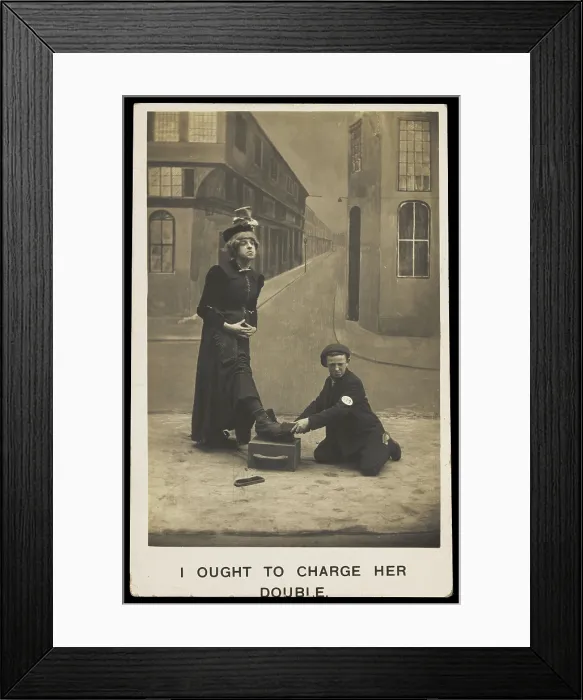 Framed Print : A shoeshine boy cleans the boots of a man in drag, c1905. Creator: Unknown Framed Print : A shoeshine boy cleans the boots of a man in drag, c1905. Creator: Unknown