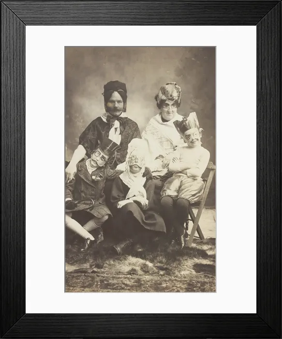 Framed Print : A family, all members wearing grotesque masks, the father in drag, c1910. Creator: Unknown Framed Print : A family, all members wearing grotesque masks, the father in drag, c1910. Creator: Unknown