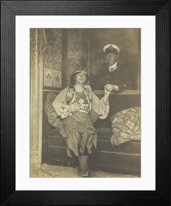 Framed Print : A sailor holds hands with a man in elaborate drag, [between 1910 and 1999?]. Creator: Unknown