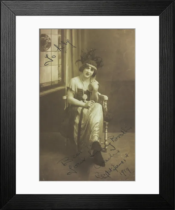 Framed Print : A man in drag (Charlie) sits face-on, wearing detailed costume, with a window painted... 1919. Creator: Unknown Framed Print : A man in drag (Charlie) sits face-on, wearing detailed costume, with a window painted... 1919. Creator: Unknown