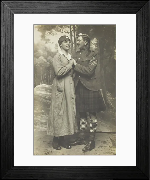 Framed Print : Two soldiers playing in a military concert party embrace: one is in drag and the... [1910-1919]. Creator: Unknown
