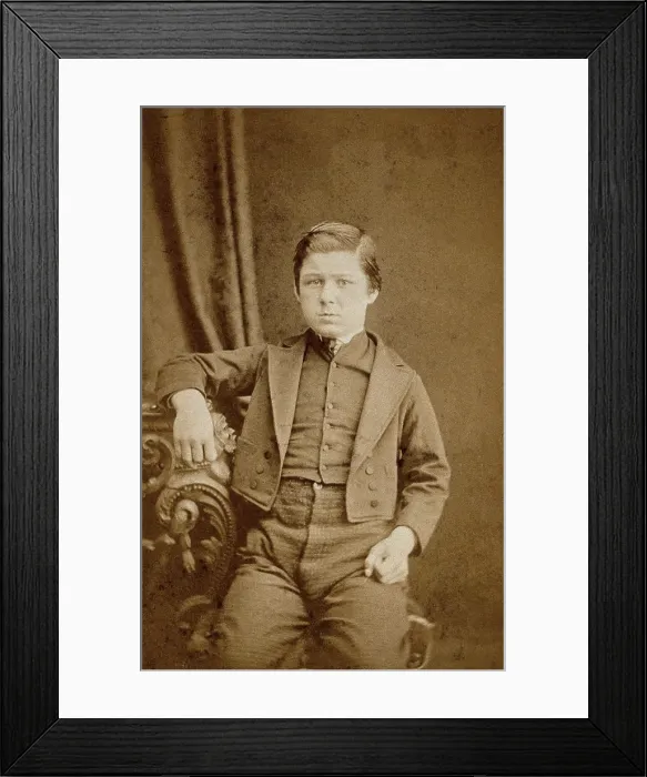 Framed Print : A seated young man with clenched fists, leaning against an ornate table, c1890s. Creator: AE Scales Framed Print : A seated young man with clenched fists, leaning against an ornate table, c1890s. Creator: AE Scales