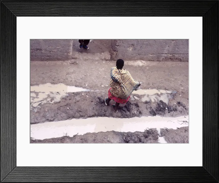 Framed Print : Woman in muddy street, Mopti, Mali, 1990. Creator: Amanda Waite Framed Print : Woman in muddy street, Mopti, Mali, 1990. Creator: Amanda Waite